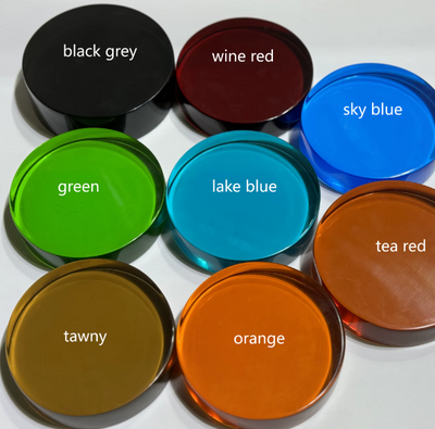 Kleurenoverzicht van acht ronde resin-monsters voor vrijstaande badkuipen, gepresenteerd als afzonderlijke cirkels met naamlabels: black grey, wine red, sky blue, green, lake blue, tea red, tawny en orange; dient als visuele referentie voor kleuropties in modern badkamerdesign